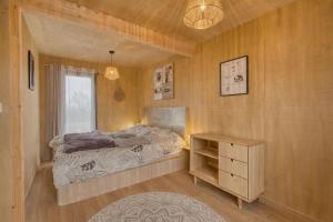 a bedroom with a bed and a desk and a window at Studio bois Le Colibri à Chambley in Hagéville