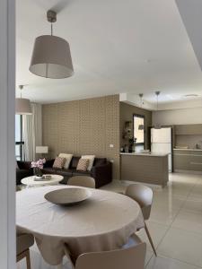 a kitchen and a living room with a table and chairs at appartement privé exceptionnel in Netanya