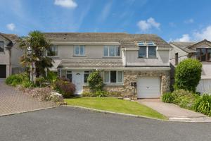 a house with a palm tree and a driveway at Ocean Parc in Carbis Bay