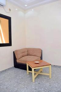 a couch sitting in a room with a coffee table at Residence LaFina in Saly Portudal