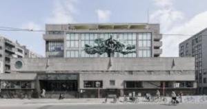 a large building with a tree in front of it at Bérylune Centrum in Ostend