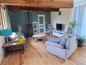 a living room with a couch and a table at Chez les Wawas in Sainte-Agathe-dʼAliermont