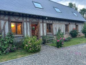 a house with a bunch of flowers in front of it at Chez les Wawas in Sainte-Agathe-dʼAliermont