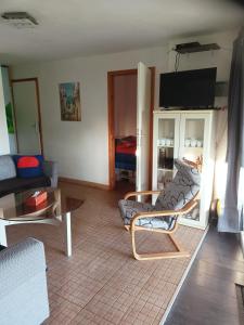 a living room with a couch and a table at Kamenec chata Thermal Kamenec in Kaluža