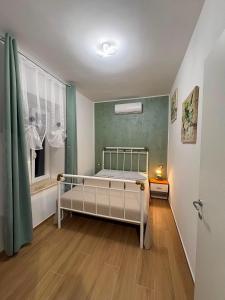 a small bedroom with a bed and a window at ADA City Apartment in Palestrina