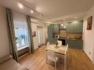a kitchen and dining room with a table and chairs at ADA City Apartment in Palestrina