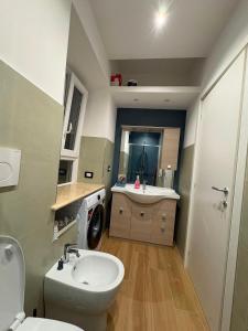 a bathroom with a white toilet and a sink at ADA City Apartment in Palestrina +13 photos