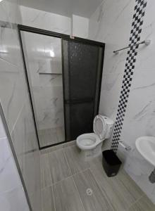 a bathroom with a shower and a toilet and a sink at EDIFICIO BENHUr in Cúcuta +4 photos