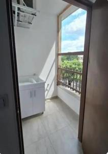 a bathroom with a sink and a large window at EDIFICIO BENHUr in Cúcuta