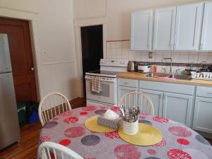 a kitchen with a table with two chairs and a sink at Cozy Tree House in Saint John