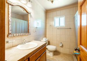 a bathroom with a sink and a toilet and a mirror at Jerry in San Felipe +31 photos