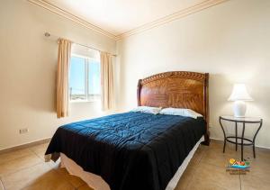 a bedroom with a bed and a table and a window at Jerry in San Felipe