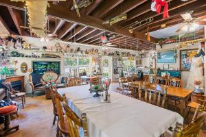 a dining room with tables and chairs in a restaurant at Nolichuckey Bluffs Bed & Breakfast Cabins in Greeneville