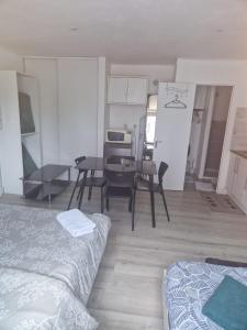a living room with a table and a dining room at Studio la Romagne in La Romagne +17 photos