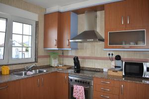 a kitchen with a sink and a stove top oven at Agra Boa in Bornalle