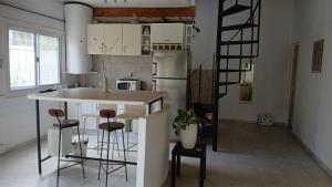 a kitchen with a island in the middle of a room at PARQUE LELOIR, ITUZAINGO in Villa Leloir