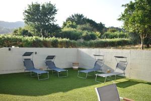 a group of chairs sitting on the grass at Agra Boa in Bornalle