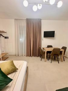 a living room with a table and a tv at A casa di Cetta in Melendugno