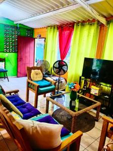 a living room with colorful curtains and a tv at Rancho María in San Diego