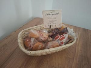 a basket filled with chocolate and a sign in it at Villa Anna in Hanioti