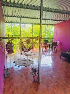 a room with a patio with a hammock and tables at Rancho María in San Diego