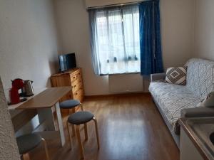 a living room with a couch and a table at Studio PARAY CENTRE LOGIS 12 in Paray-le-Monial