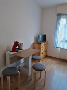 a small room with a table and two chairs at Studio PARAY CENTRE LOGIS 12 in Paray-le-Monial +6 photos