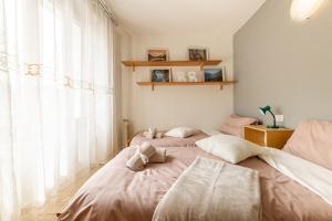 a bedroom with two beds and a large window at Puria Rustic Lake View Apartment in Valsolda