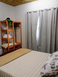 a bedroom with a bed and a gray curtain at Hogar en el corazón de Tilcara in Tilcara