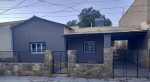 a blue house with a fence in front of it at Hogar en el corazón de Tilcara in Tilcara