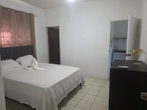 a bedroom with a bed and a dresser in it at Ackee Haven Comfortable Spacious Home in Poor Mans Corner +5 photos