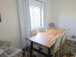 a dining room with a wooden table and chairs at Ackee Haven Comfortable Spacious Home in Poor Mans Corner
