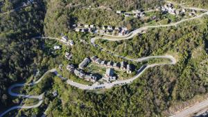 an aerial view of a house on a mountain with a road at Appartement Orelle spa et piscine in Orelle +16 photos