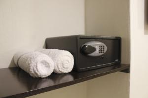 a towel dispenser on a shelf in a bathroom at Urbania Office Hotel in Tuxtla Gutiérrez +3 photos