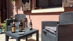 two bottles of beer on a table on a patio at Porta del Carmine in Comacchio