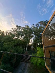 a balcony of a house with trees in the background at CASA CONTAINER BOSQUE Y MAR in Mar del Plata