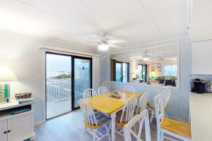 a kitchen and dining room with a table and chairs at Crystal Sands 403 in Ocean City
