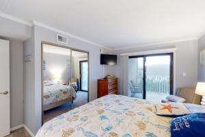 a bedroom with a bed and a large mirror at Crystal Sands 403 in Ocean City +9 photos