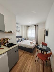 a kitchen and a bedroom with a bed and a table at Astraluxe in Fažana