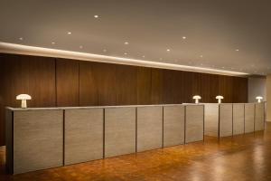 a lobby with wooden walls and a row of desks at ROW NYC at Times Square in New York