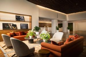 a lobby with couches and chairs in a building at ROW NYC at Times Square in New York