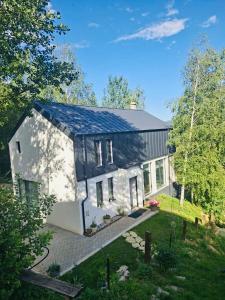 a house with a solar panel on the roof at Forest House Chalet Bran in Predeluţ