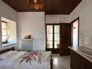 a bedroom with a bed and a sink and a tub at Little Graceland in Afissos