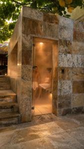 two men sitting at a table behind a door at Lombok Hotel & SPA antes Hotel Casablanca in Guaduas