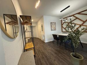 a dining room with a table and a mirror at Between in Lübeck