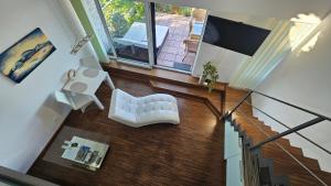 an overhead view of a living room with a white chair at Apartmán Pálava 1 s terasou a výhledem na jezero in Pavlov +12 photos