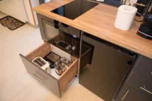 a kitchen with a wooden counter top with a dishwasher at Casa Criss in Sinaia