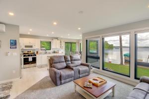 a living room with a couch and a table at Lakefront Northwoods Cabin w/ Shared Dock & Views! in Tower