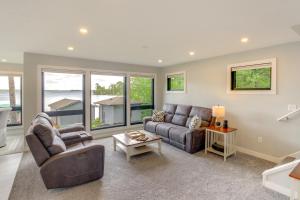 a living room with a couch and a table at Lakefront Northwoods Cabin w/ Shared Dock & Views! in Tower