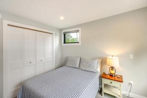 a bedroom with a bed and a night stand with a lamp at Lakefront Northwoods Cabin w/ Shared Dock & Views! in Tower